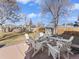 Backyard patio with white Adirondack chairs and a hammock for relaxation at 1221 Ulster St, Denver, CO 80220
