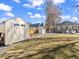 Backyard features a storage shed, patio, and outdoor seating, with a spacious lawn at 1221 Ulster St, Denver, CO 80220