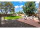 Grassy backyard featuring a patio with a seating area, shed, mature trees, and hammock at 1221 Ulster St, Denver, CO 80220