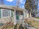 Inviting front porch with a charming wreath and cozy seating, creating a welcoming entrance at 1221 Ulster St, Denver, CO 80220