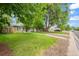 Charming single-story home features a well-manicured lawn, mature trees, and inviting curb appeal at 1221 Ulster St, Denver, CO 80220