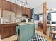 Kitchen featuring green island, stainless steel appliances, and granite countertops at 1221 Ulster St, Denver, CO 80220