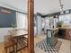 Eat-in kitchen with green island, stainless steel refrigerator, and adjacent dining area at 1221 Ulster St, Denver, CO 80220