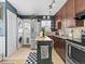 Bright kitchen featuring stainless steel appliances, green island, and washer/dryer hookups at 1221 Ulster St, Denver, CO 80220