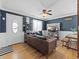 Inviting living room with a cozy brown leather couch, modern decor, and hardwood flooring at 1221 Ulster St, Denver, CO 80220