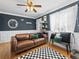 Inviting living area with hardwood floors, natural light, a comfortable sofa, and stylish decor at 1221 Ulster St, Denver, CO 80220