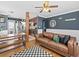 Spacious living room flowing into the kitchen, featuring hardwood floors and modern furnishings at 1221 Ulster St, Denver, CO 80220