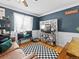 Stylish living room featuring modern decor, dark blue walls, and hardwood floors at 1221 Ulster St, Denver, CO 80220