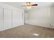 Spacious bedroom featuring neutral carpet and ceiling fan with lighting at 9385 E Center Ave # 1B, Denver, CO 80247