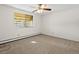 Bedroom featuring natural light, neutral carpet, and large window view at 9385 E Center Ave # 1B, Denver, CO 80247