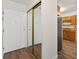 Hallway features a closet with mirrored doors and leads to an eat-in kitchen at 9385 E Center Ave # 1B, Denver, CO 80247