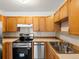 Bright kitchen with wooden cabinets and stainless steel appliances at 9385 E Center Ave # 1B, Denver, CO 80247