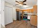 Eat-in kitchen featuring updated appliances, ceiling fan and plenty of storage space at 9385 E Center Ave # 1B, Denver, CO 80247
