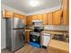 Cozy kitchen with wooden cabinets and stainless steel appliances at 9385 E Center Ave # 1B, Denver, CO 80247