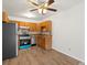 View of kitchen with wood cabinets and stainless steel appliances from open concept living area at 9385 E Center Ave # 1B, Denver, CO 80247