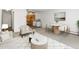 Open-concept living room and kitchen, featuring neutral tones and modern decor at 9385 E Center Ave # 1B, Denver, CO 80247