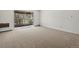Spacious living room with carpeting and slider to exterior balcony at 9385 E Center Ave # 1B, Denver, CO 80247