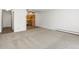 Large carpeted living room with kitchen view at 9385 E Center Ave # 1B, Denver, CO 80247