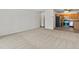 Large carpeted living room leading to kitchen with breakfast nook at 9385 E Center Ave # 1B, Denver, CO 80247