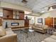 View of lobby area with comfortable seating around a stone fireplace and stylish decor at 9385 E Center Ave # 1B, Denver, CO 80247