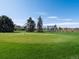 The outdoor amenities include a putting green with well-maintained grass and mature trees at 9385 E Center Ave # 1B, Denver, CO 80247