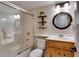 Compact bathroom featuring a vanity, toilet, and a tub-shower combination with glass doors at 805 Columbine Rd # 106, Breckenridge, CO 80424