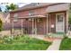 Charming backyard offers a covered patio, perfect for outdoor entertaining and relaxation with well-maintained lawn at 1259 S Elizabeth St, Denver, CO 80210