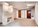 Finished basement offers cozy carpeting and a classic fireplace with a brick surround, plus two storage closets at 1259 S Elizabeth St, Denver, CO 80210