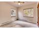 This bedroom features neutral walls, two windows for ample natural light, and a ceiling fan for added comfort at 1259 S Elizabeth St, Denver, CO 80210