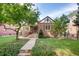 Charming brick home with a well-manicured lawn and inviting front porch at 1259 S Elizabeth St, Denver, CO 80210