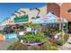 Whole Foods market with local produce and plants displayed outdoors, promoting fresh and community-sourced items at 1259 S Elizabeth St, Denver, CO 80210