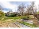 Expansive backyard with garden beds, a lush lawn, and a covered patio area perfect for outdoor gatherings at 356 Aquarius Ct, Littleton, CO 80124