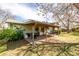 Backyard patio with pergola, outdoor furniture, a grill and lush landscaping at 356 Aquarius Ct, Littleton, CO 80124