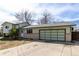 Street view of home with a large, multi-panel garage door, sunny sky above at 356 Aquarius Ct, Littleton, CO 80124