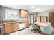 Bright eat-in kitchen with stainless steel appliances, wooden cabinets and large windows at 356 Aquarius Ct, Littleton, CO 80124