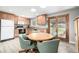 Bright eat-in kitchen with stainless steel appliances, wooden cabinets and sliding glass doors to yard at 356 Aquarius Ct, Littleton, CO 80124