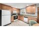 Well-lit kitchen features granite countertops, light wood cabinets and stainless steel appliances at 356 Aquarius Ct, Littleton, CO 80124