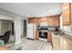 Well-lit kitchen features granite countertops, light wood cabinets and stainless steel appliances at 356 Aquarius Ct, Littleton, CO 80124