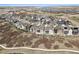 Aerial view showing the property's location within a picturesque neighborhood near a lake at 6851 Copper Sky Cir, Castle Pines, CO 80108