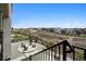 Well-manicured backyard with a stone patio, comfortable seating, and lush landscaping with views at 6851 Copper Sky Cir, Castle Pines, CO 80108