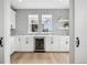 Charming bar area boasts patterned tile backsplash, white cabinets, and a convenient beverage refrigerator at 6851 Copper Sky Cir, Castle Pines, CO 80108