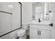 Modern bathroom featuring a glass-enclosed shower with black hardware, white cabinets, and tile floors at 6851 Copper Sky Cir, Castle Pines, CO 80108