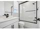 Modern bathroom with white vanity, matte black fixtures, and glass-enclosed shower with subway tile at 6851 Copper Sky Cir, Castle Pines, CO 80108