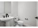 Stylish half bathroom features modern fixtures, a pedestal sink, and sleek design elements for a contemporary feel at 6851 Copper Sky Cir, Castle Pines, CO 80108