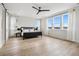 Bright bedroom with large windows, hardwood floors, and modern ceiling fan at 6851 Copper Sky Cir, Castle Pines, CO 80108