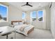 Sunny bedroom featuring white walls, plush carpet, ceiling fan, and sunny windows with neighborhood views at 6851 Copper Sky Cir, Castle Pines, CO 80108