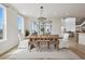 Bright dining room featuring a stylish chandelier and access to an outdoor patio at 6851 Copper Sky Cir, Castle Pines, CO 80108