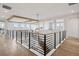 Bright hallway with hardwood floors, modern railing, and coffered ceiling with recessed lighting at 6851 Copper Sky Cir, Castle Pines, CO 80108