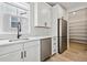 Bright kitchen features stainless steel appliances, white cabinets and undermount sink at 6851 Copper Sky Cir, Castle Pines, CO 80108