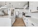 Bright open kitchen featuring a large center island, custom cabinets and stainless steel appliances at 6851 Copper Sky Cir, Castle Pines, CO 80108